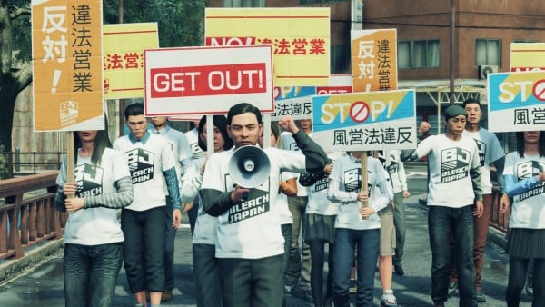 Yakuza: Like a Dragon. Bleach Japan marches with conservative signs, mostly in Japanese - the words "NO!," "GET OUT!," AND "STOP!" are written in English.